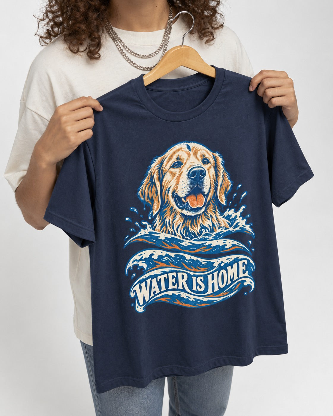 Golden Retriever Water Is Home Ocean Wave Graphic T-Shirt in Navy, held up on a hanger