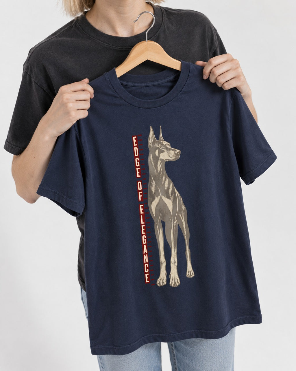 Doberman Edge of Elegance Height Chart Graphic T-Shirt in Navy, held up on a hanger