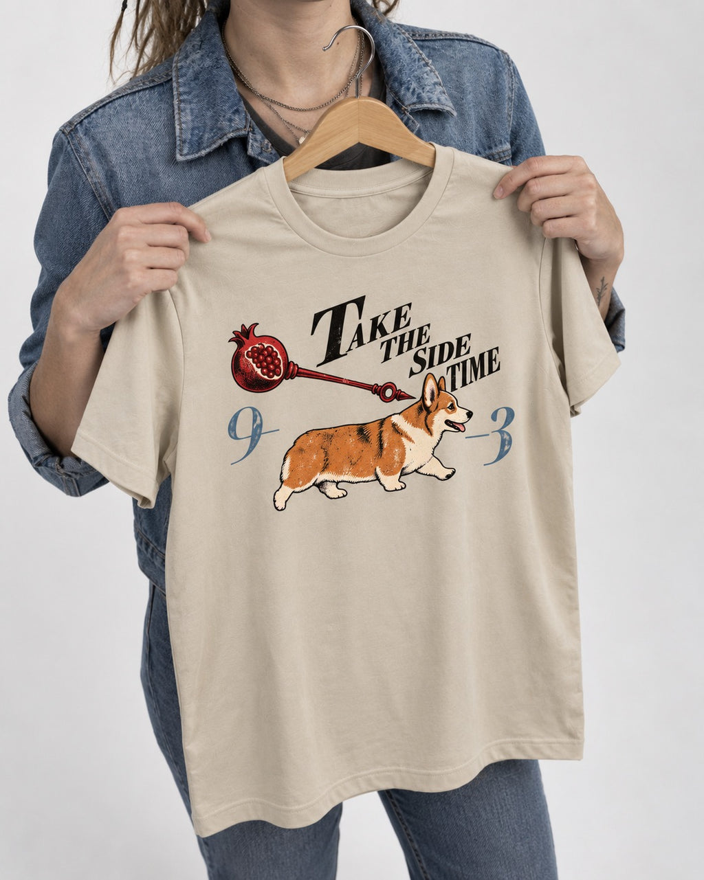 Corgi Take the Side Time T-Shirt in Sand, held up on a hanger