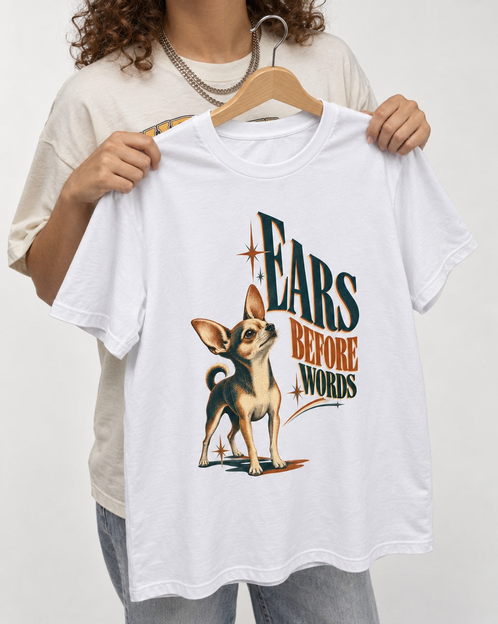 Chihuahua Ears Before Words Retro Typography T-Shirt in White, held up on a hanger