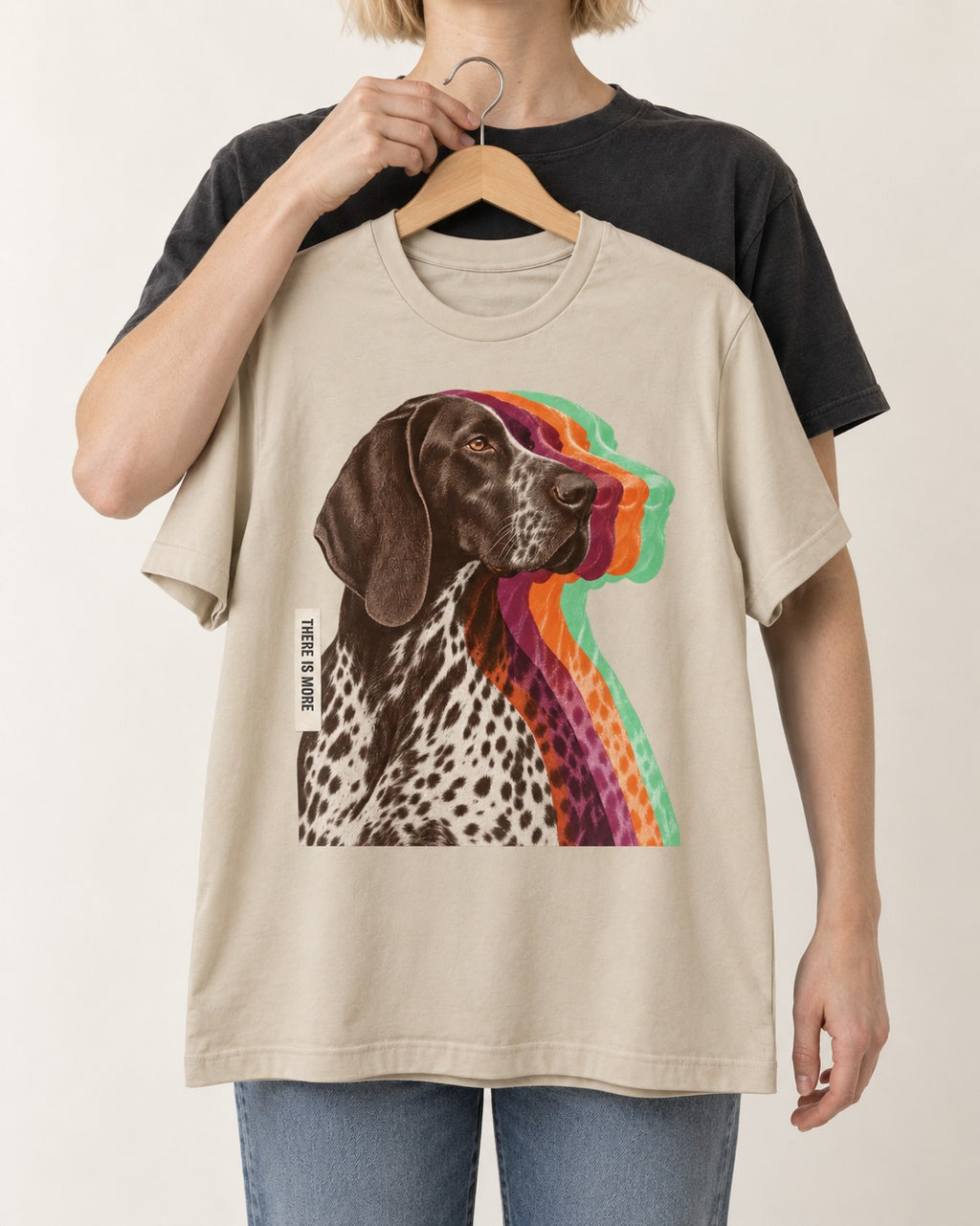 There Is More German Shorthaired Pointer T-Shirt in Sand, held up on a hanger