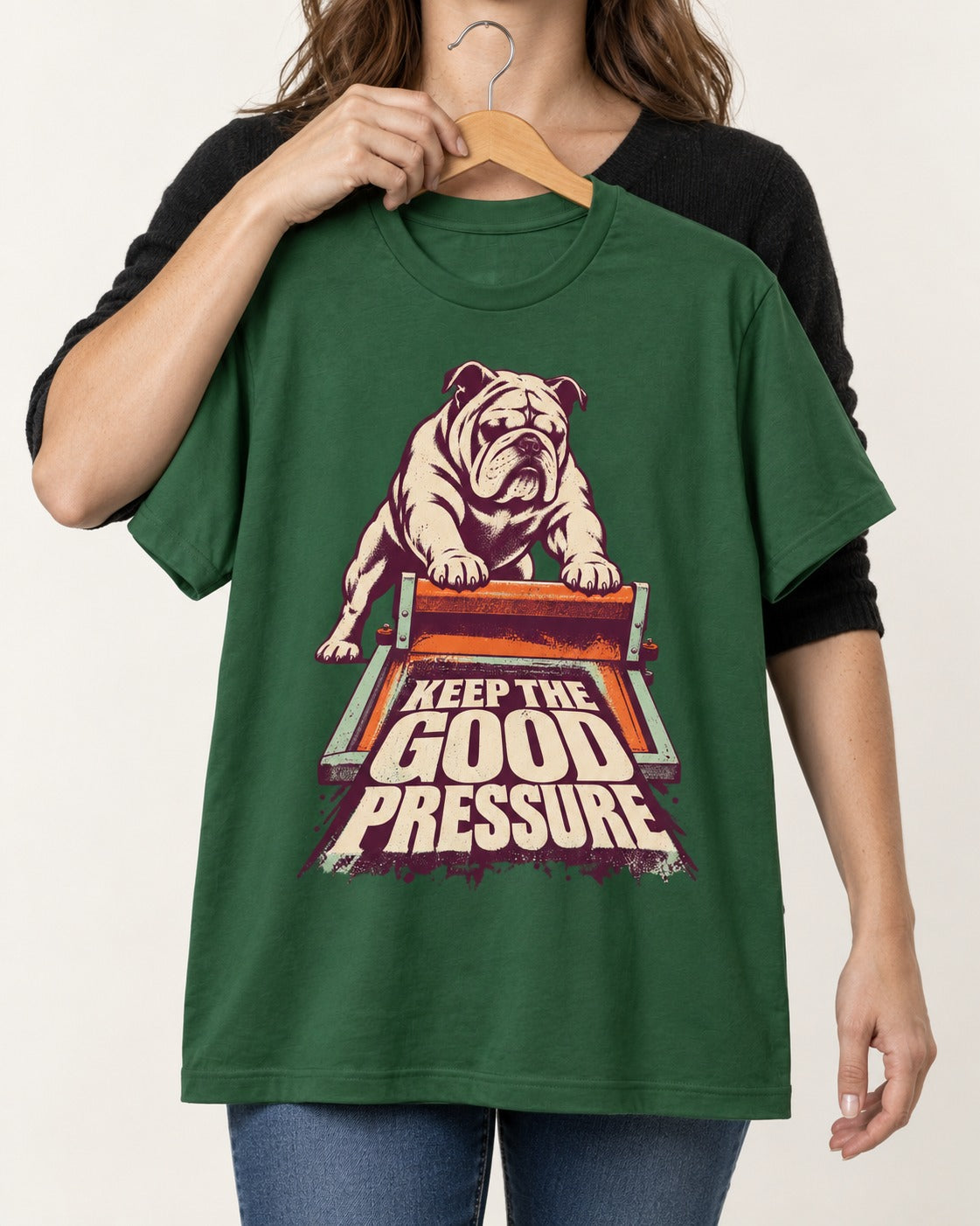 English Bulldog Keep the Good Pressure Printing Press Graphic T-Shirt in Forest Green, held up on a hanger