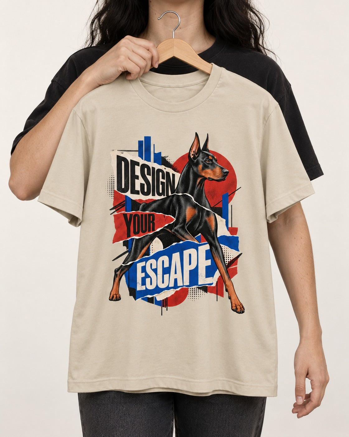 Doberman Escape T-Shirt in Sand, held up on a hanger