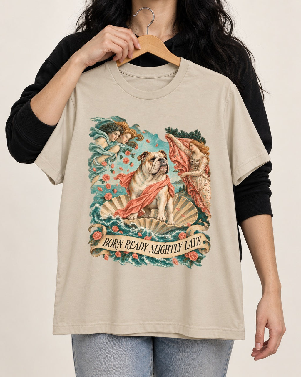 Born Ready Slightly Late English Bulldog T-Shirt in Sand, held up on a hanger