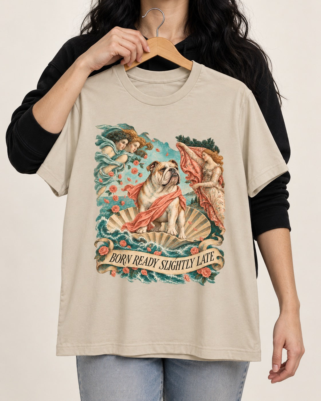 Born Ready Slightly Late English Bulldog T-Shirt in Sand, held up on a hanger