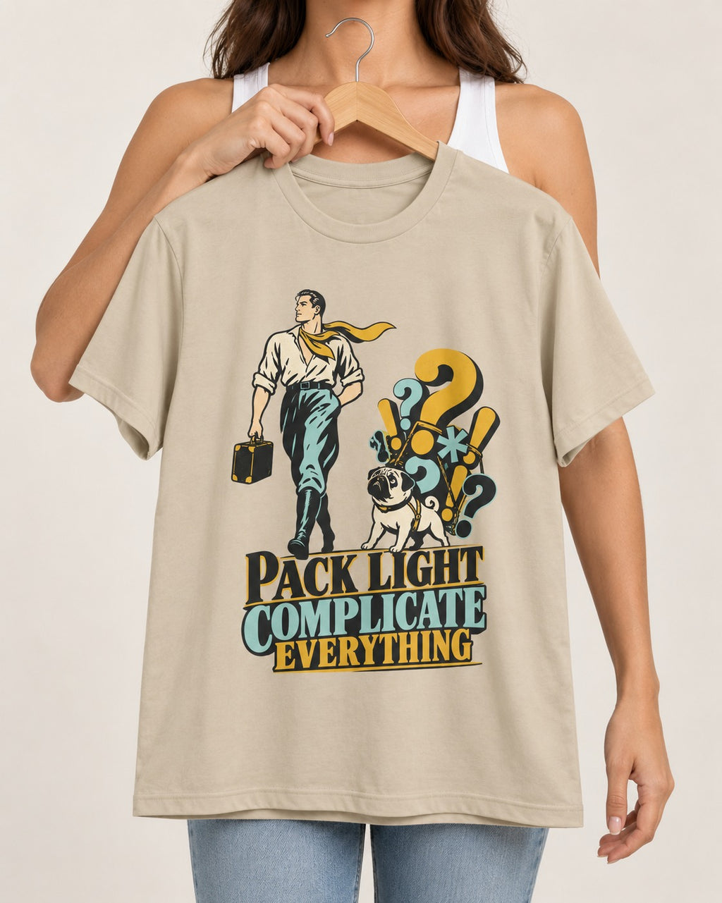 Pug Pack Light Complicate Everything T-Shirt in Sand, held up on a hanger