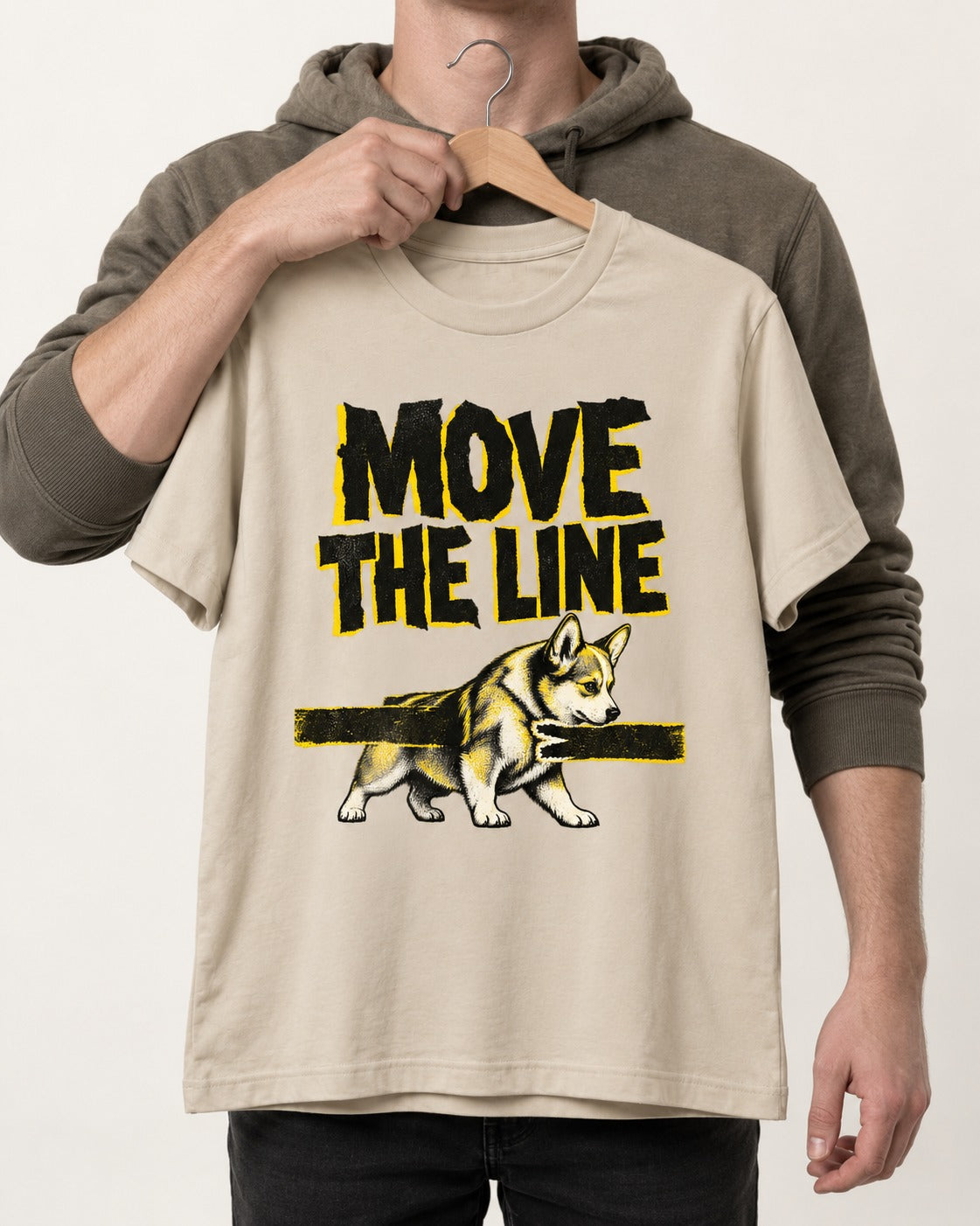 Corgi Move the Line T-Shirt in Sand, held up on a hanger