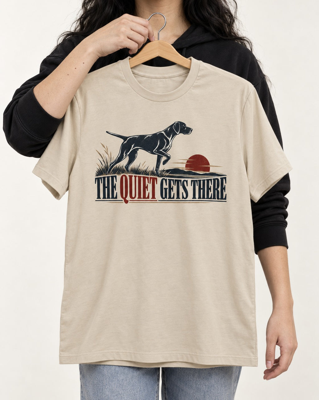 The Quiet Gets There German Shorthaired Pointer T-Shirt in Sand, held up on a hanger