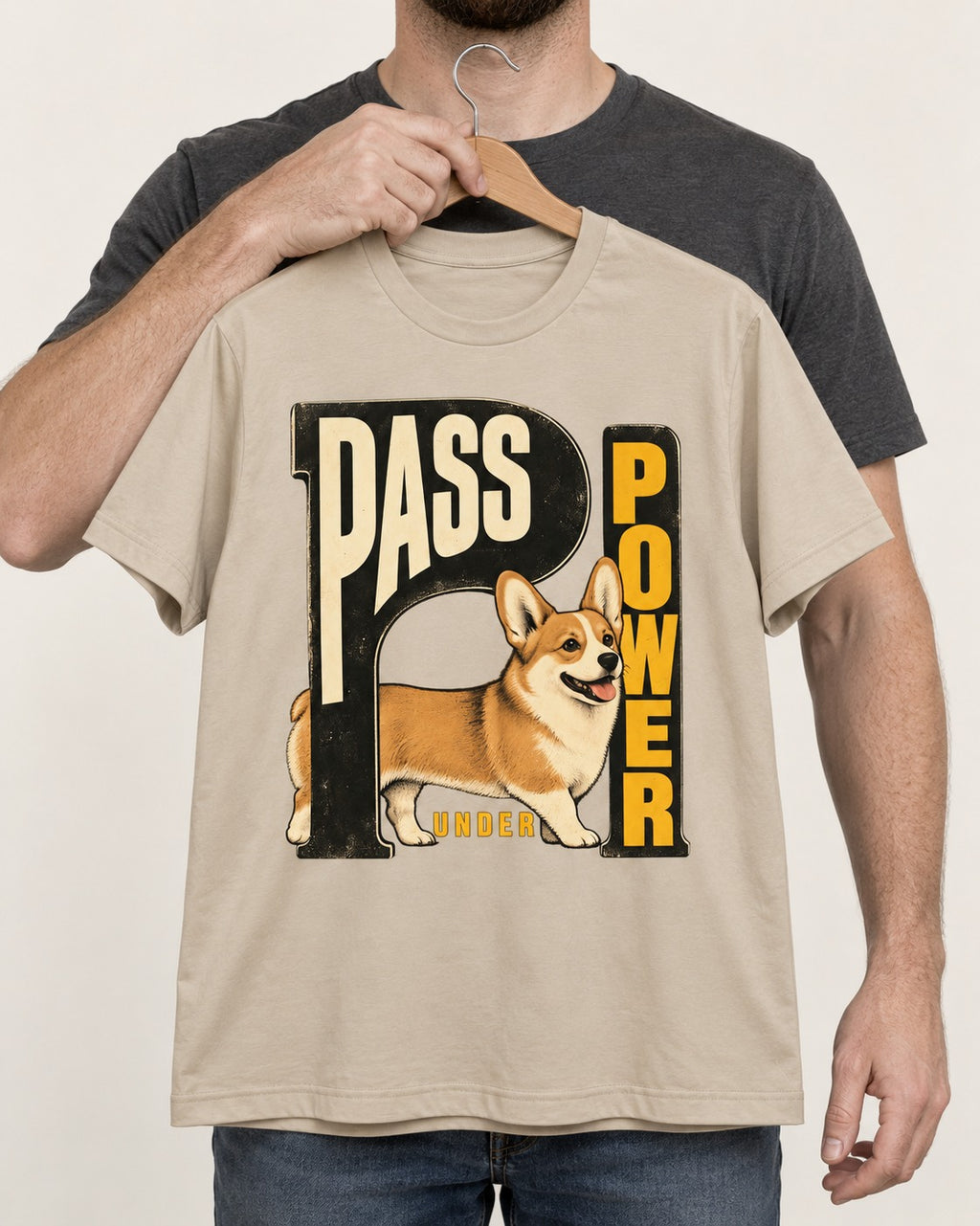 Corgi Power T-Shirt in Sand, held up on a hanger