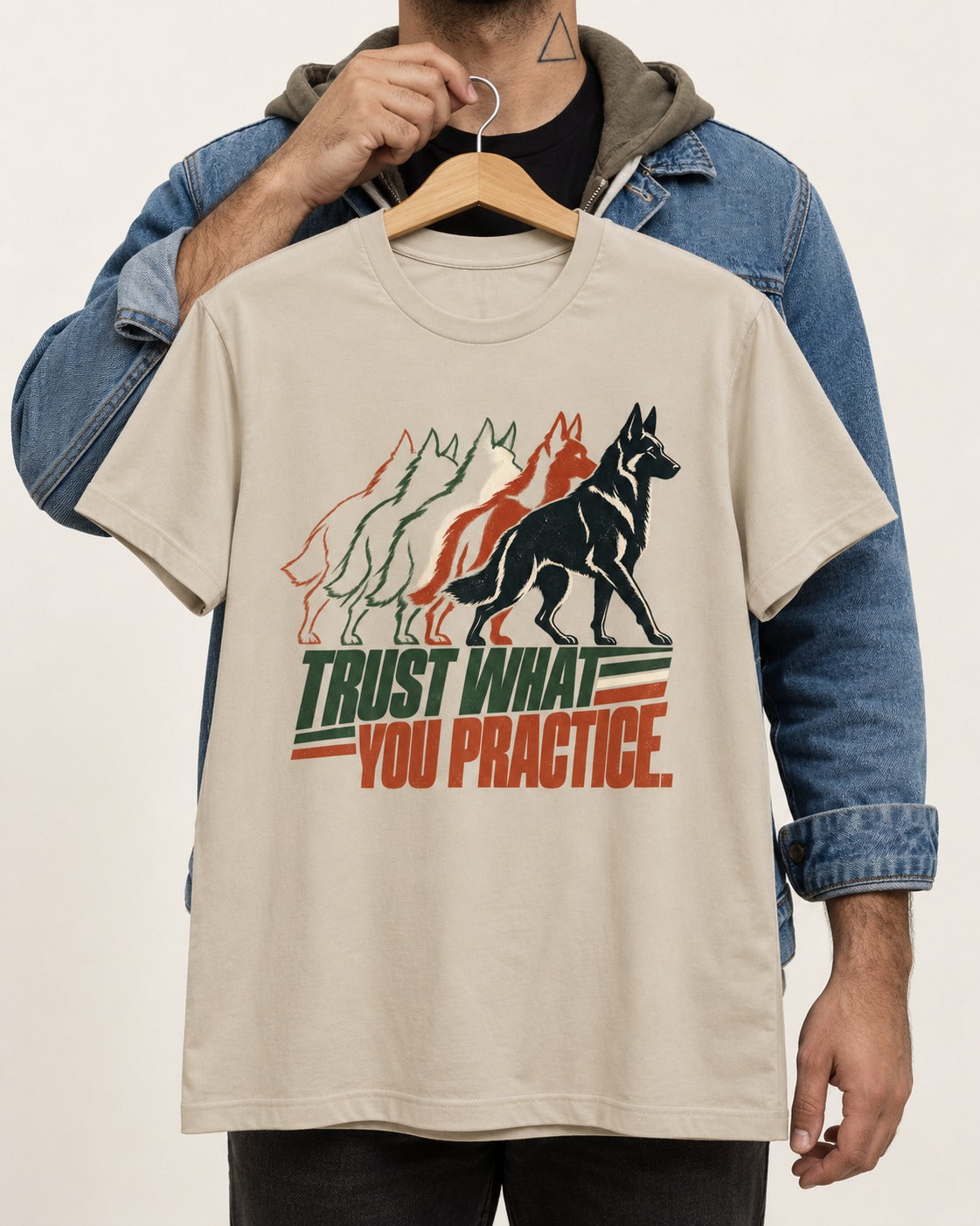 Trust What You Practice German Shepherd Dog T-Shirt in Sand, held up on a hanger