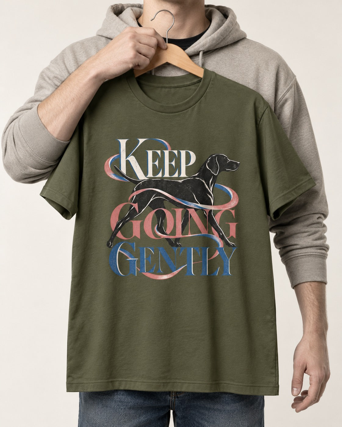 German Shorthaired Pointer Keep Going Gently Walking Graphic T-Shirt in Heather Military Green, held up on a hanger