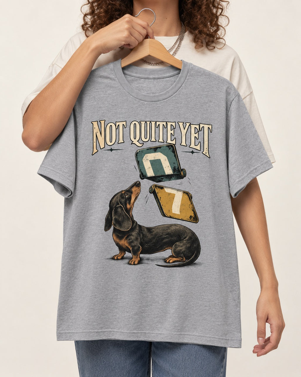 Not Quite Yet Dachshund T-Shirt in Sport Grey, held up on a hanger