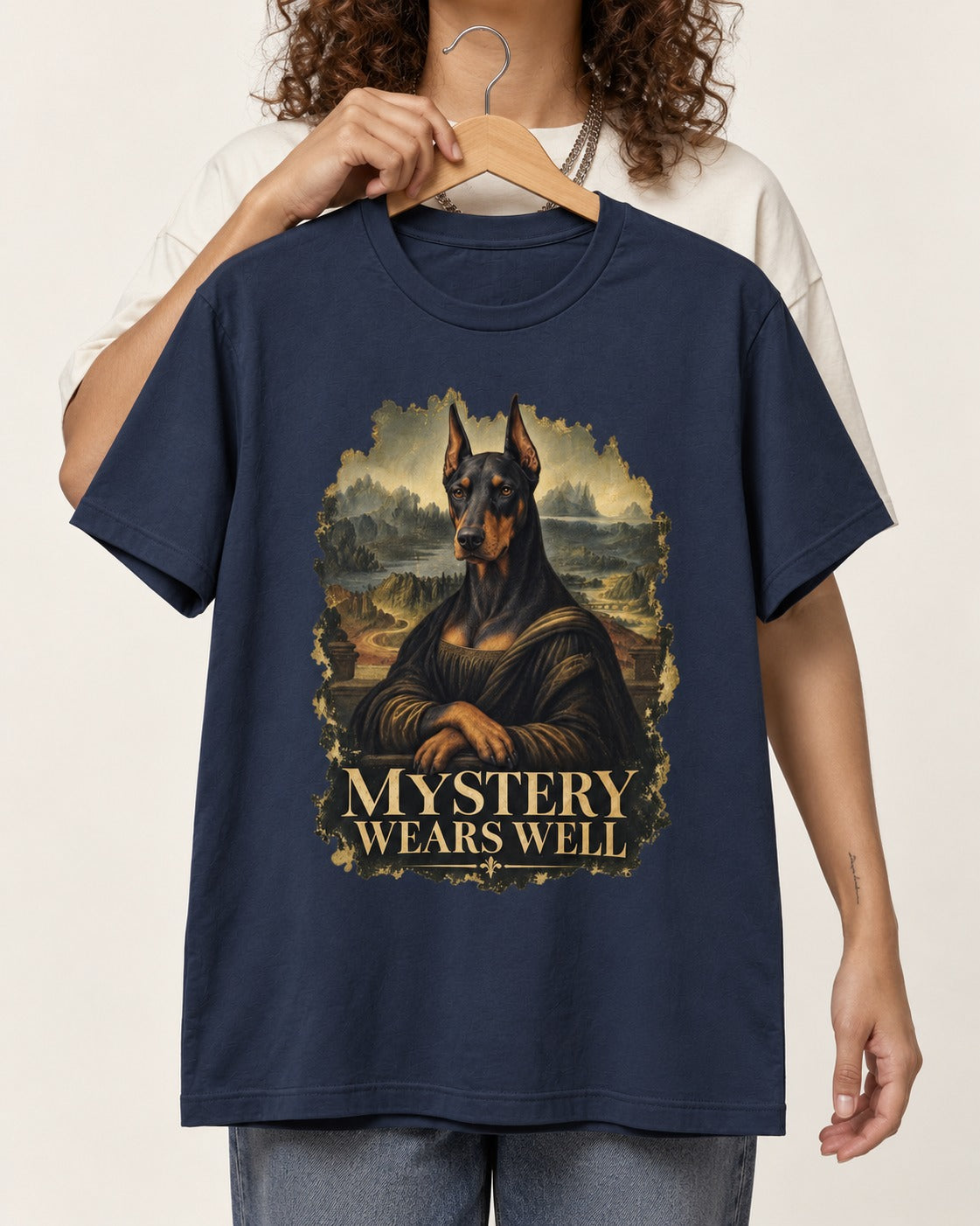 Doberman Mystery Wears Well Renaissance Portrait Graphic T-Shirt in Navy, held up on a hanger