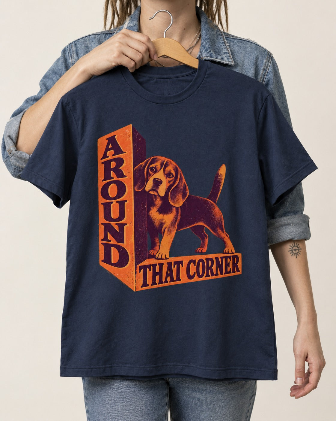 Beagle Around That Corner Graphic T-Shirt in Navy, held up on a hanger