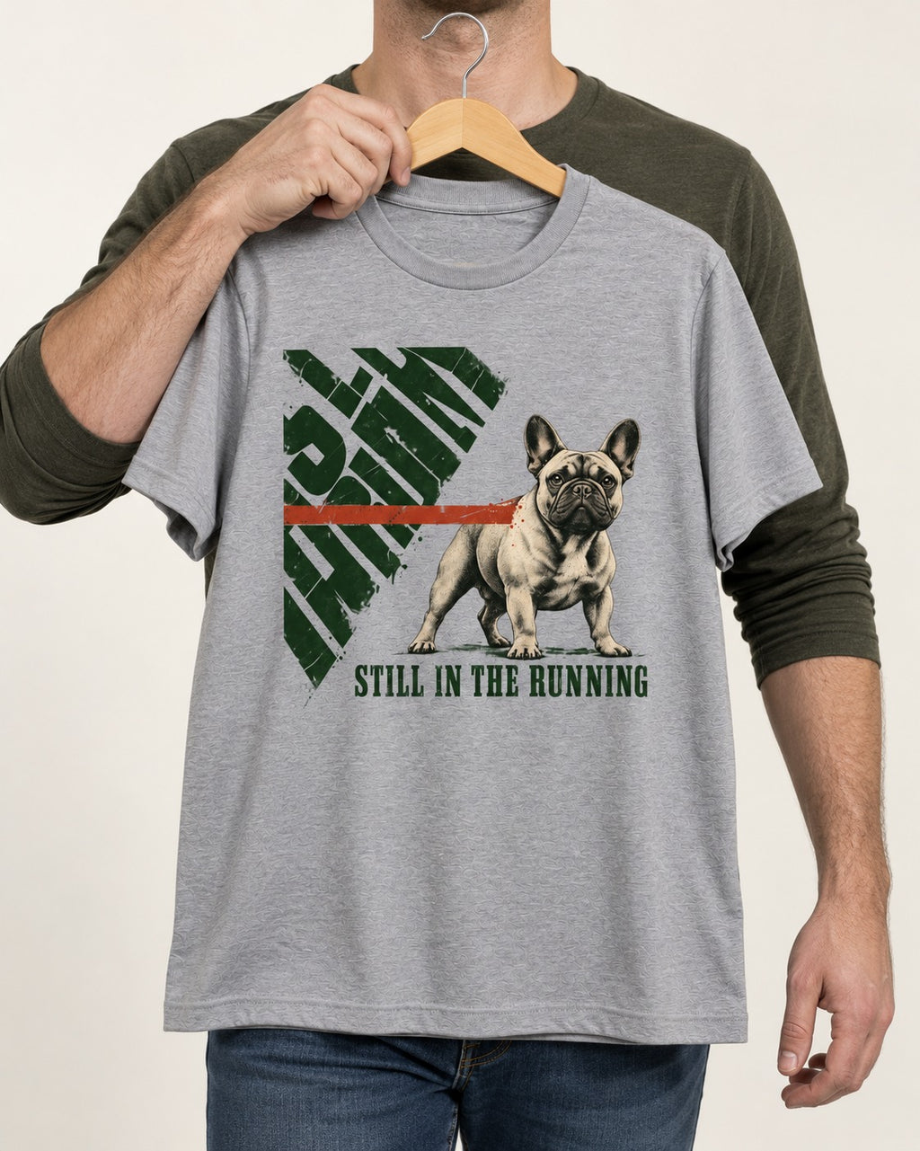 Frenchie Still in the Running T-Shirt in Sport Grey, held up on a hanger