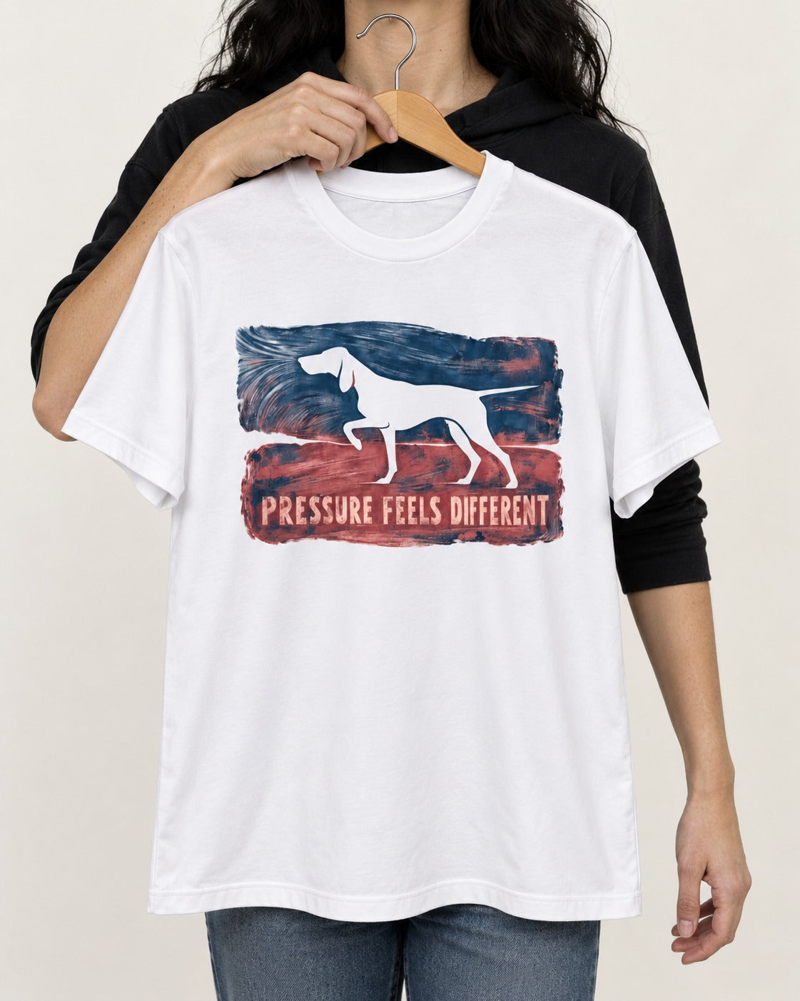 German Shorthaired Pointer Pressure Feels Different Monotype Graphic T-Shirt in White, held up on a hanger