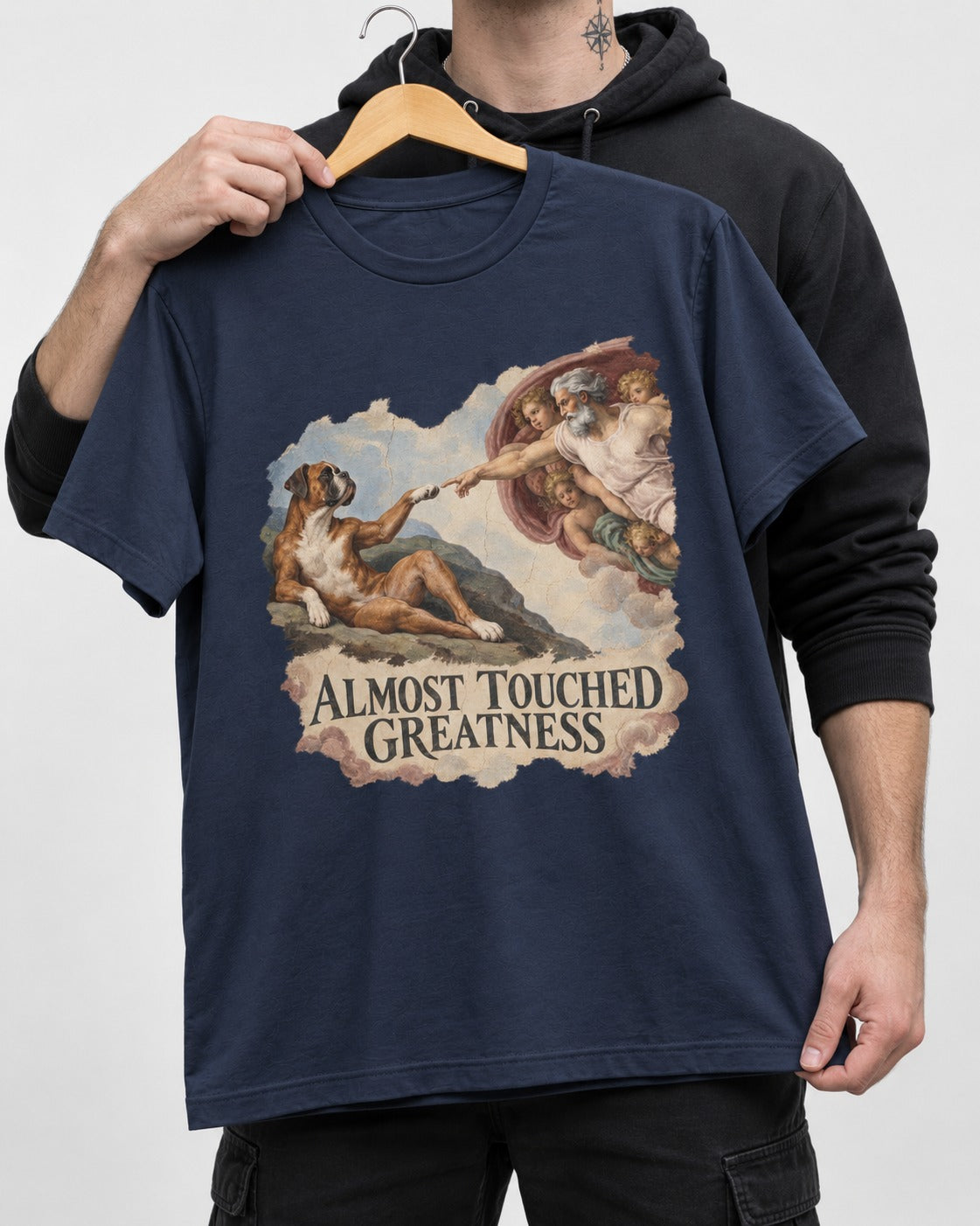 Almost Touched Greatness Boxer Creation Fresco Graphic T-Shirt in Navy, held up on a hanger