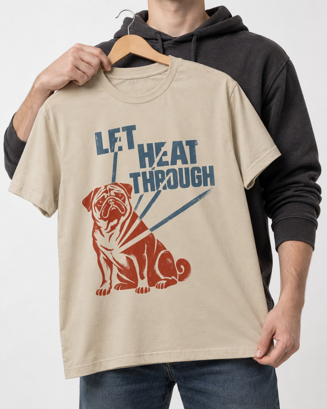 Let the Pug Through T-Shirt in Sand, held up on a hanger