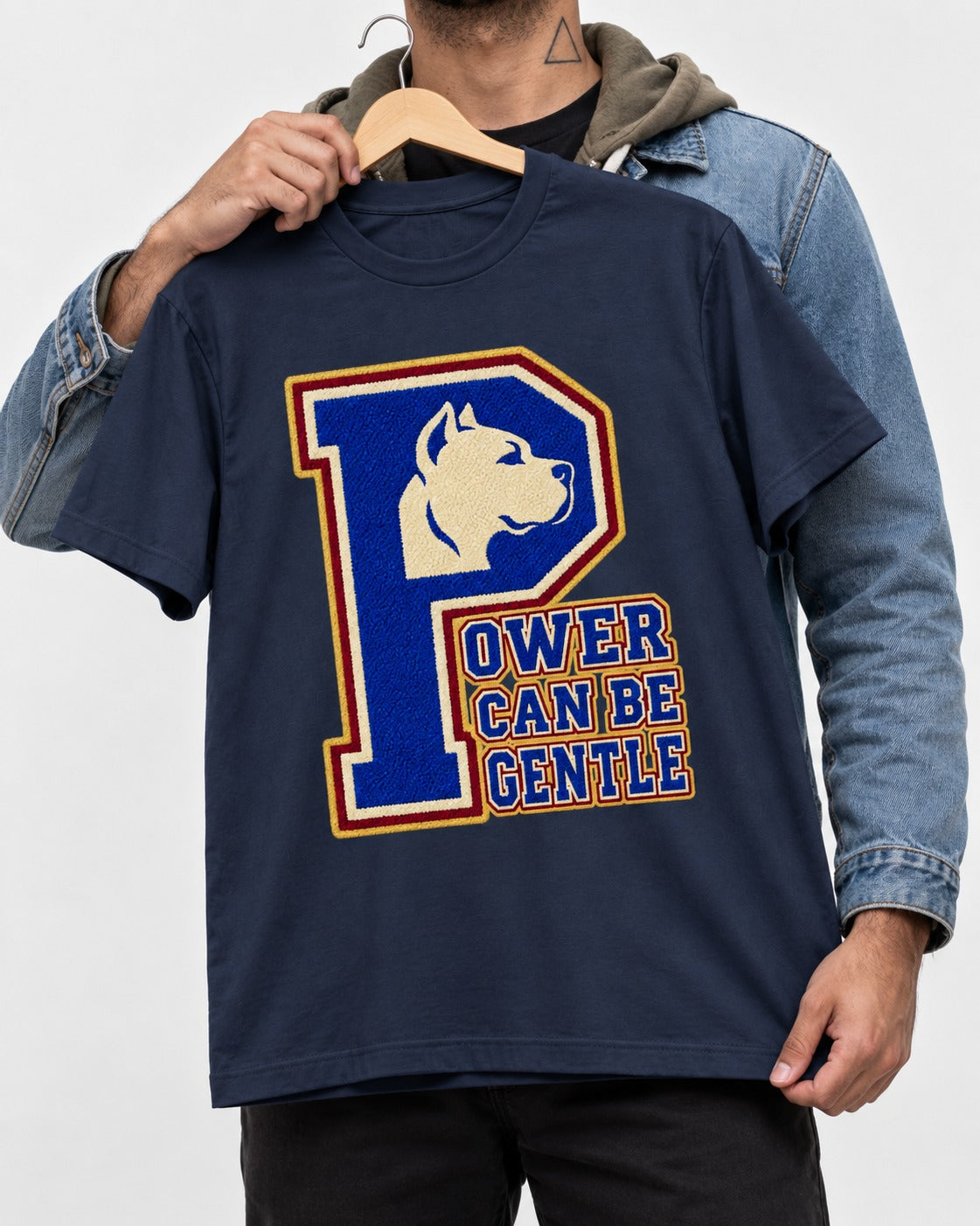Pitbull Power Can Be Gentle Varsity Graphic T-Shirt in Navy, held up on a hanger