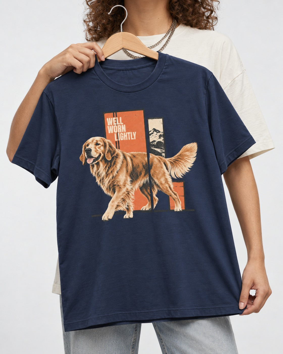 Golden Retriever Well Worn Lightly Mountain Graphic T-Shirt in Navy, held up on a hanger