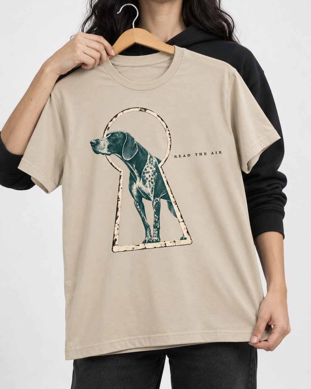 Read the Air German Shorthaired Pointer T-Shirt in Sand, held up on a hanger