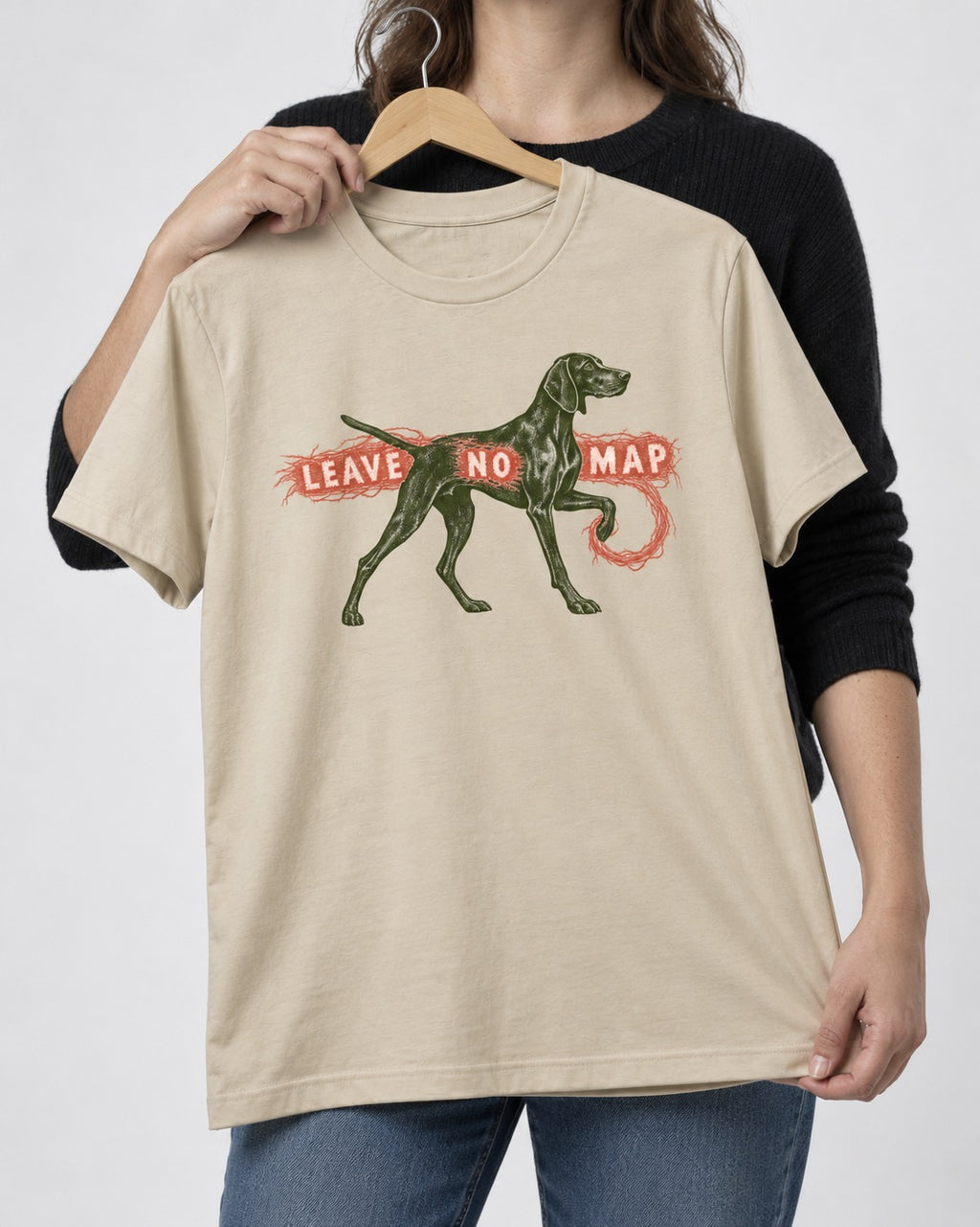 Leave No Map German Shorthaired Pointer T-Shirt in Sand, held up on a hanger