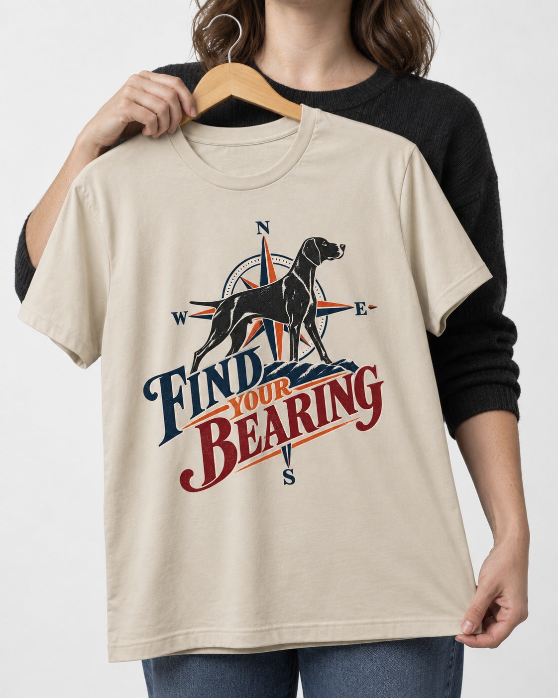 Find Your Bearing German Shorthaired Pointer T-Shirt in Sand, held up on a hanger