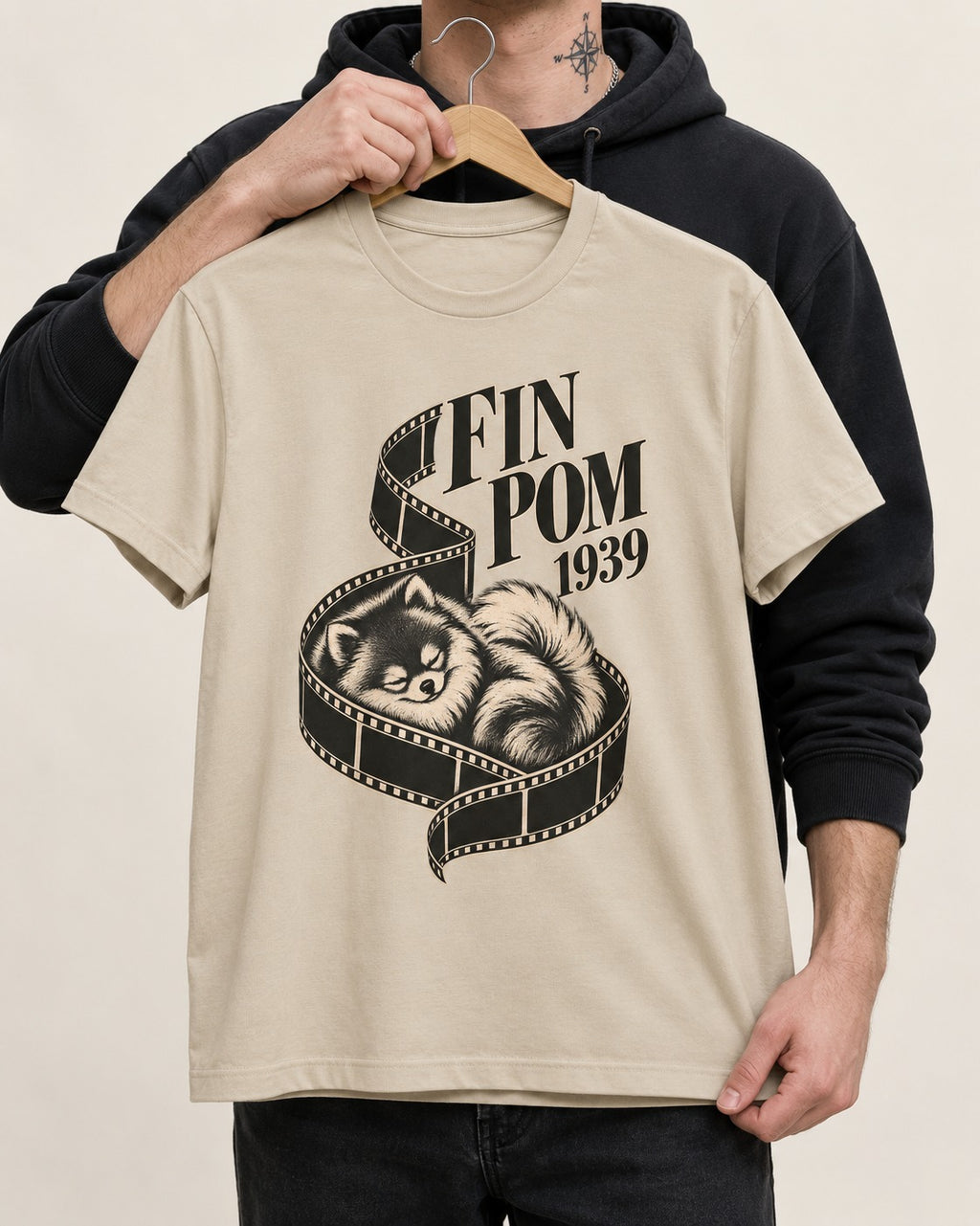 Fin Pomeranian T-Shirt in Sand, held up on a hanger