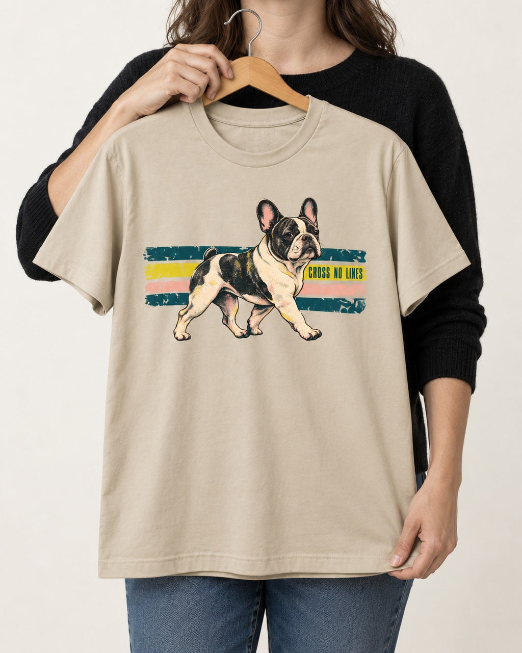 Frenchie Cross No Lines T-Shirt in Sand, held up on a hanger