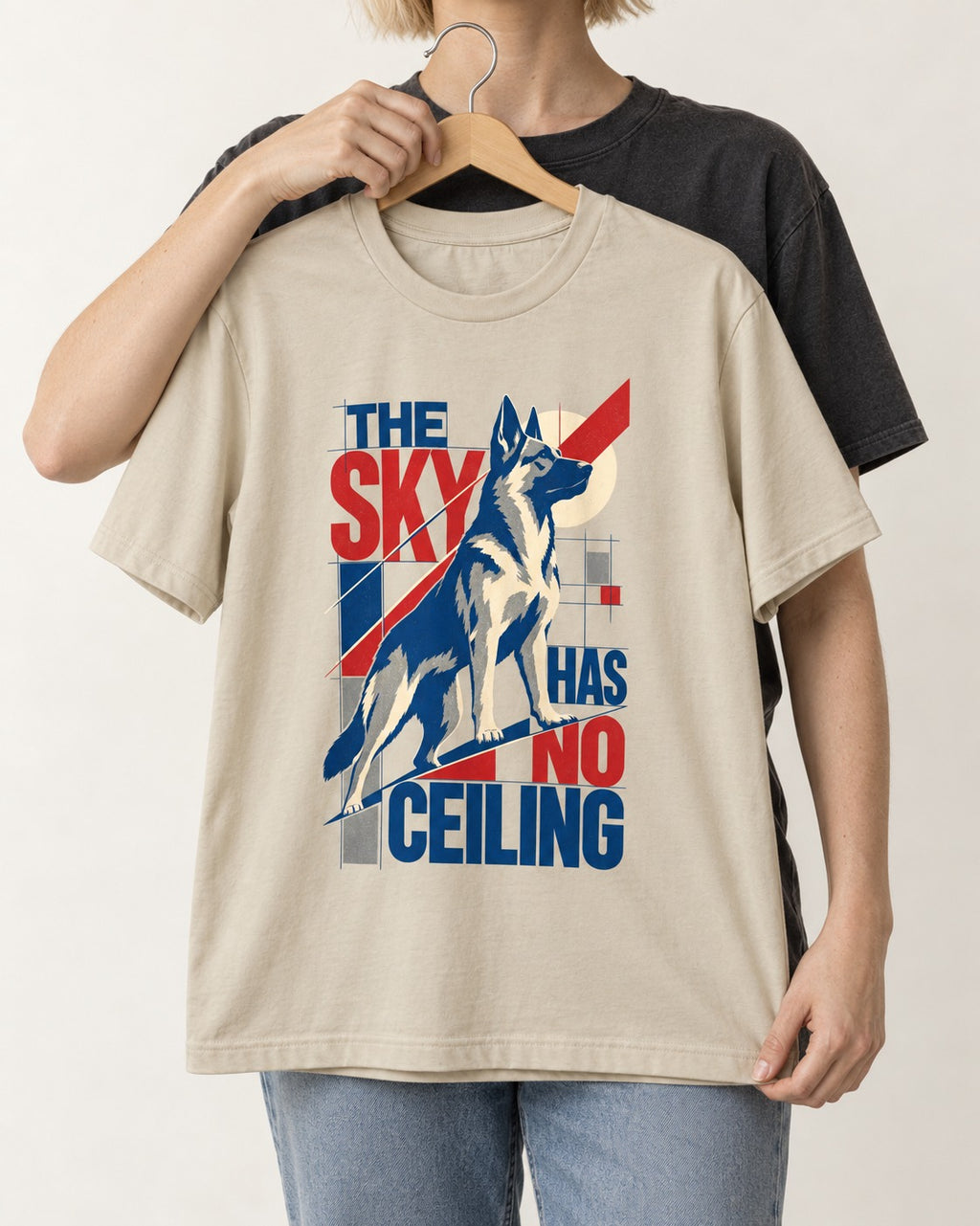 Sky Has No Ceiling German Shepherd Dog T-Shirt in Sand, held up on a hanger