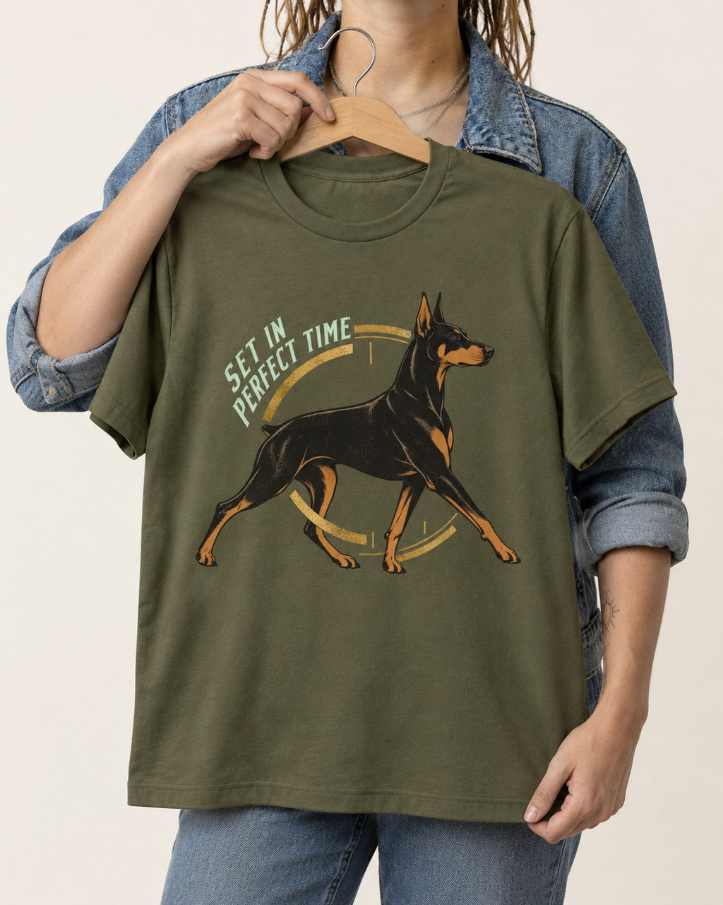 Doberman Set in Perfect Time Clock Stride Graphic T-Shirt in Heather Military Green, held up on a hanger