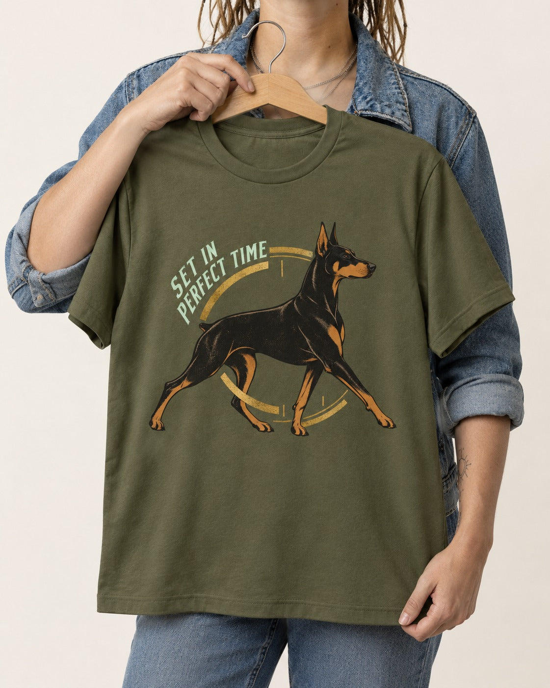 Doberman Set in Perfect Time Clock Stride Graphic T-Shirt in Heather Military Green, held up on a hanger