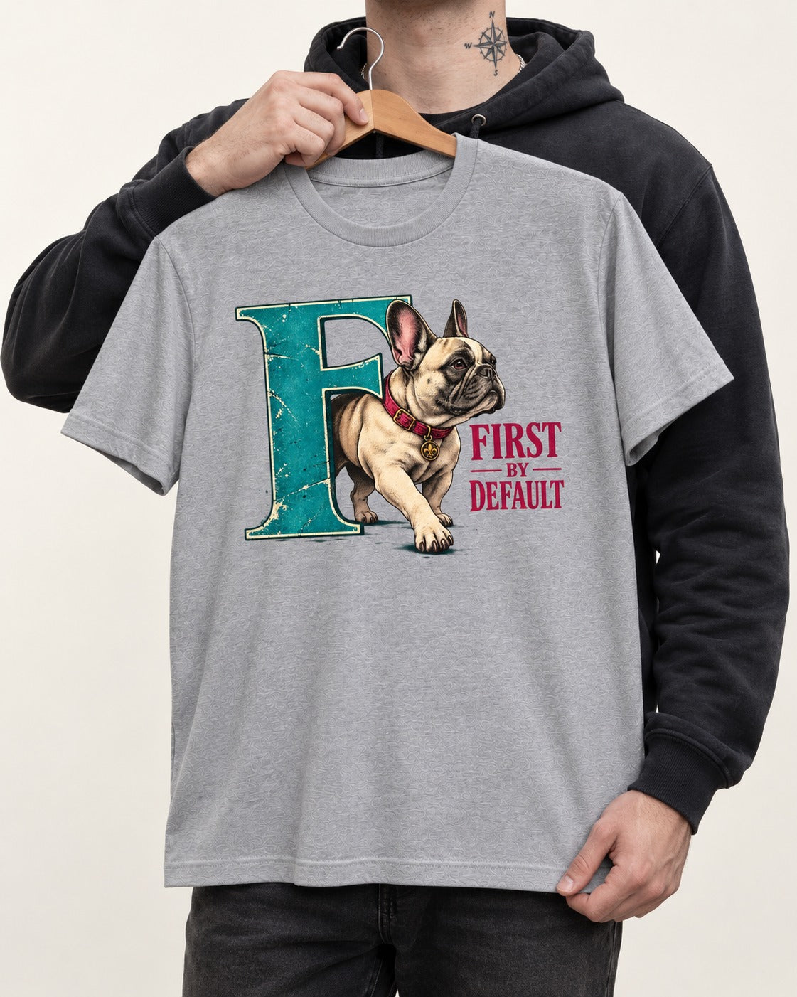 Frenchie First by Default Teal F Graphic T-Shirt in Sport Grey, held up on a hanger