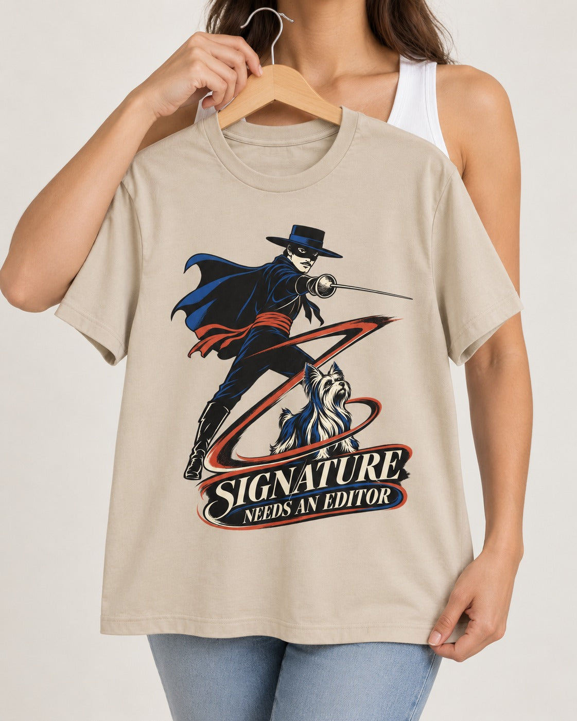 Yorkshire Terrier Signature Needs an Editor T-Shirt in Sand, held up on a hanger