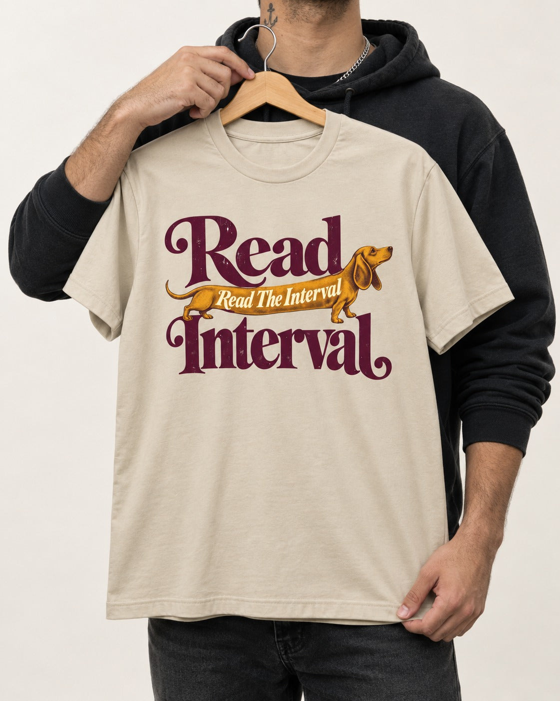 Read the Dachshund Interval T-Shirt in Sand, held up on a hanger
