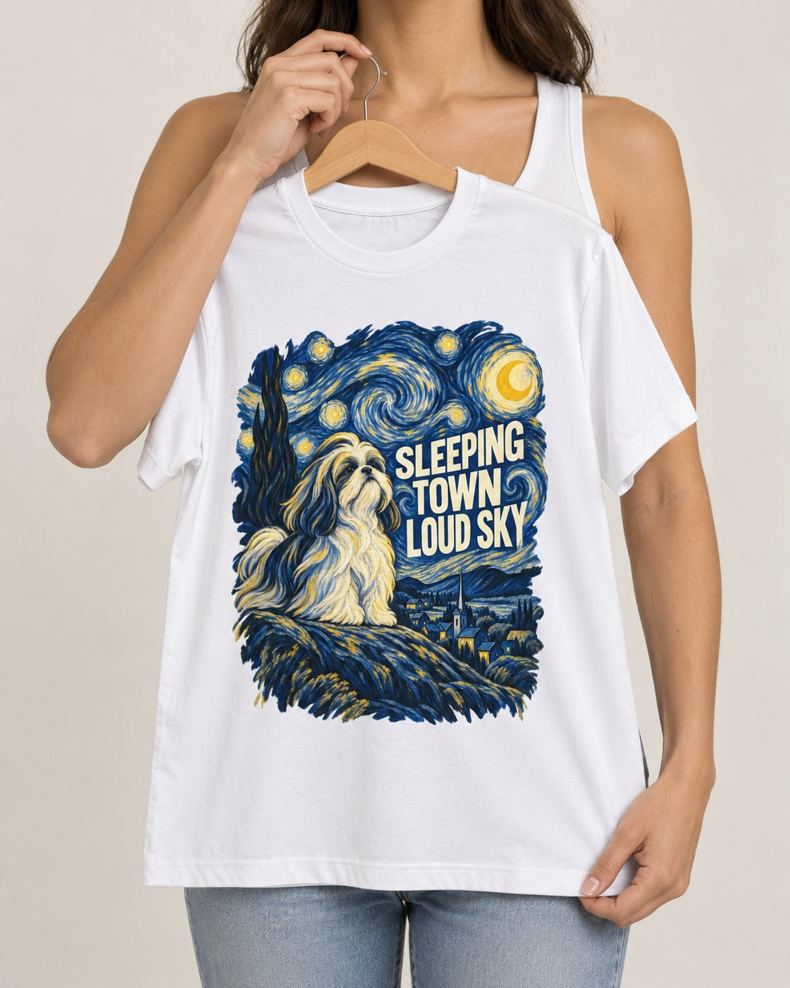 Shih Tzu Sleeping Town Loud Sky Swirling Night Graphic T-Shirt in White, held up on a hanger