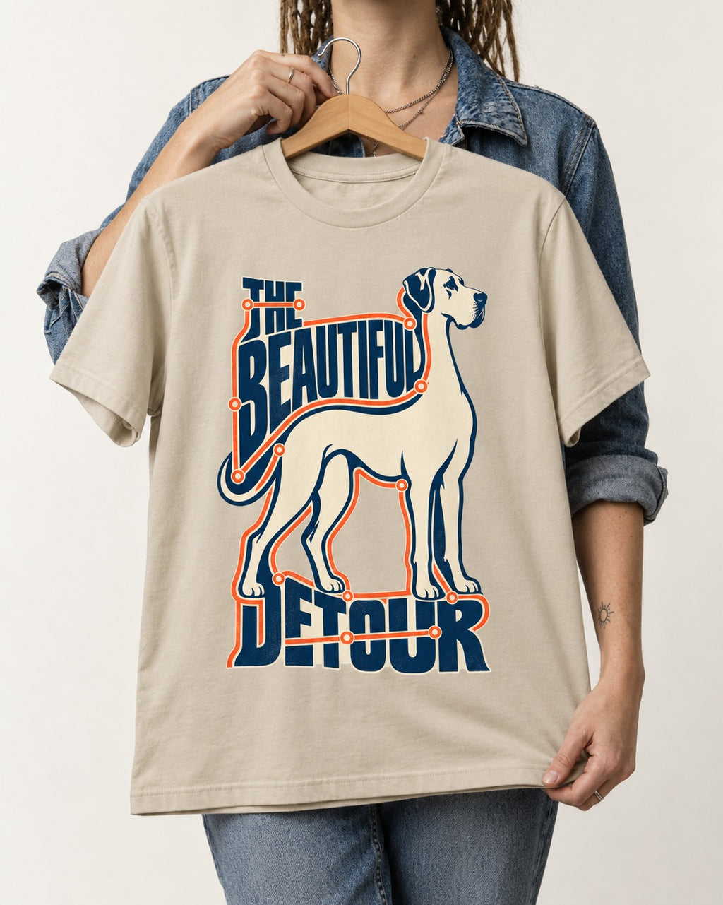 Great Dane's Beautiful Detour T-Shirt in Sand, held up on a hanger