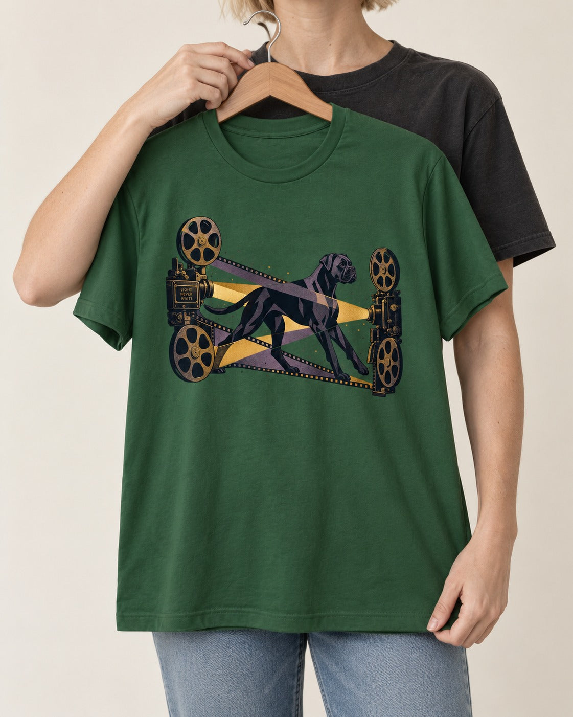 Light Never Waits Boxer Cinema Graphic T-Shirt in Forest Green, held up on a hanger