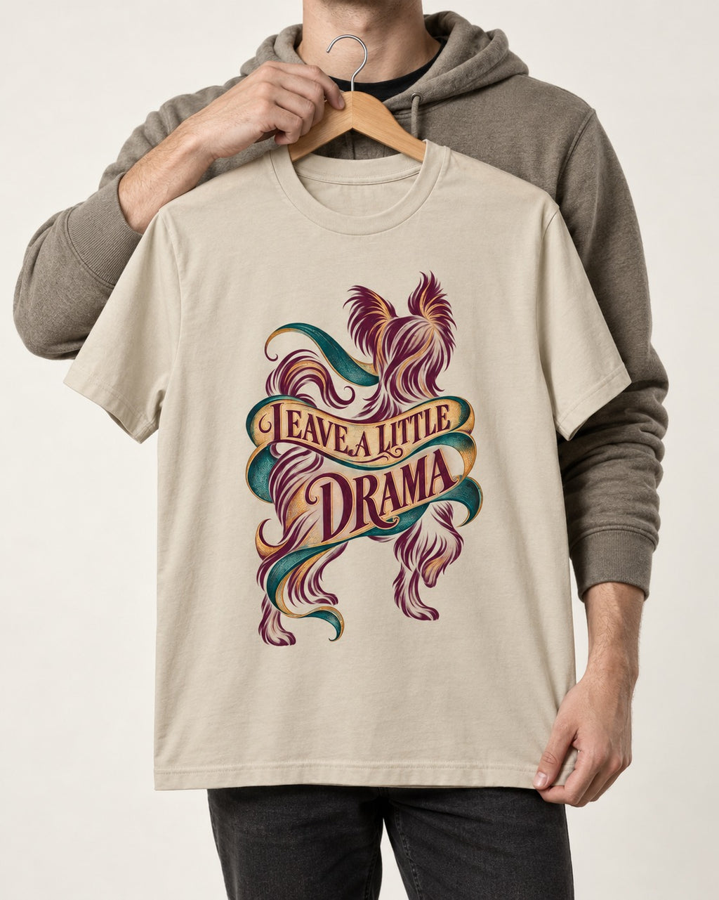 Leave a Little Drama Yorkshire Terrier T-Shirt in Sand, held up on a hanger