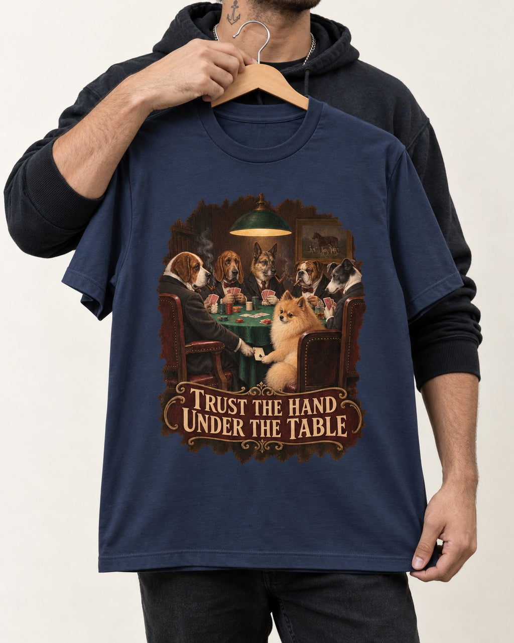 Pomeranian Trust the Hand Under the Table Poker Dogs Graphic T-Shirt in Navy, held up on a hanger