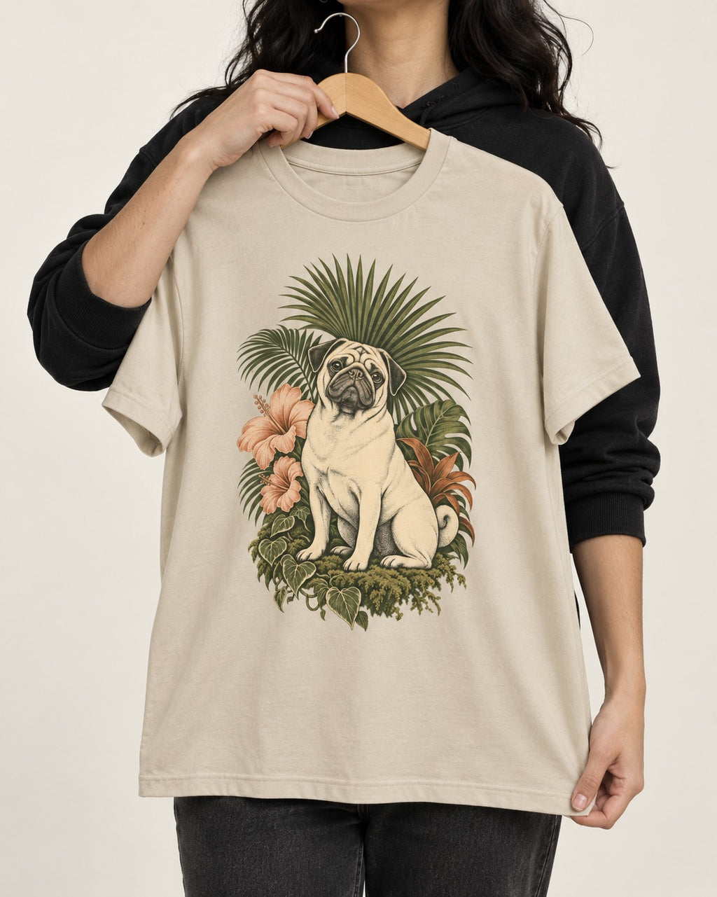 Pug Paradise T-Shirt in Sand, held up on a hanger