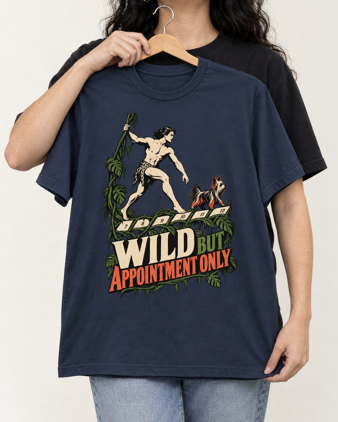 Yorkshire Terrier Wild but Appointment Only Jungle Calendar Graphic T-Shirt in Navy, held up on a hanger