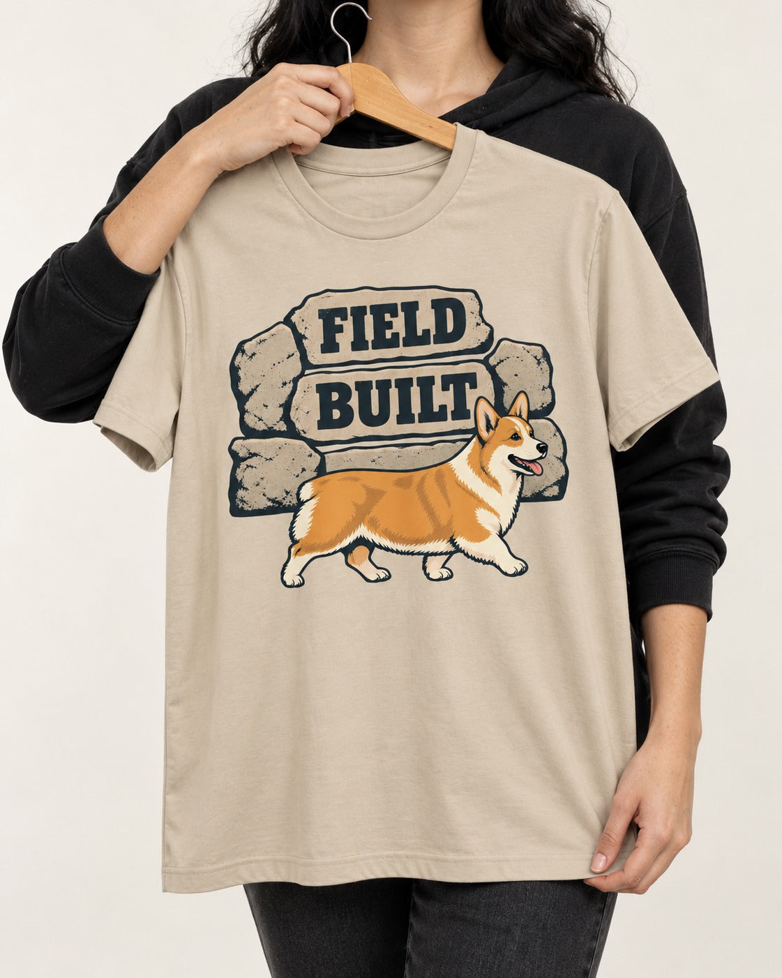 Field Built Corgi T-Shirt in Sand, held up on a hanger