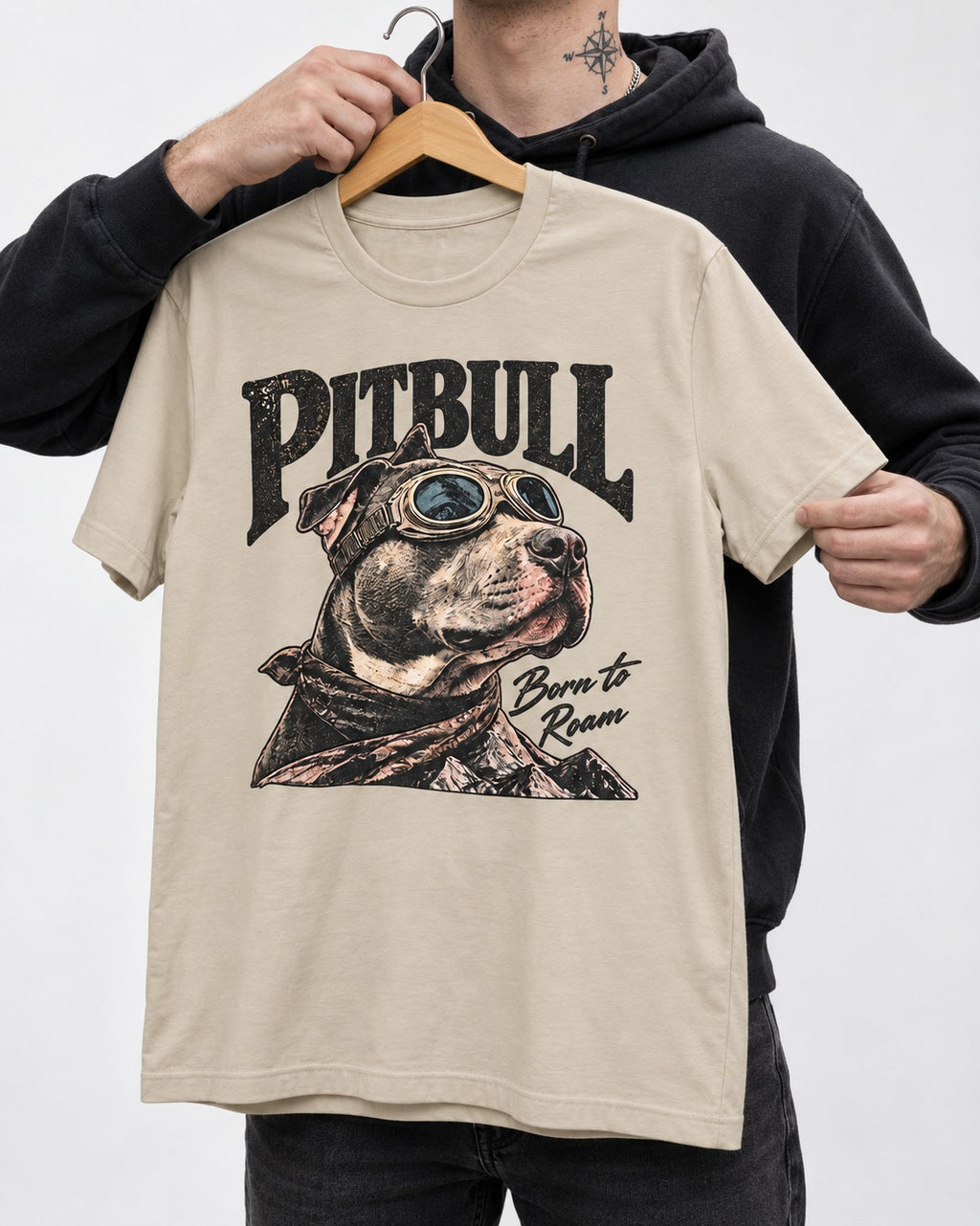 Pitbull Born to Roam T-Shirt in Sand, held up on a hanger