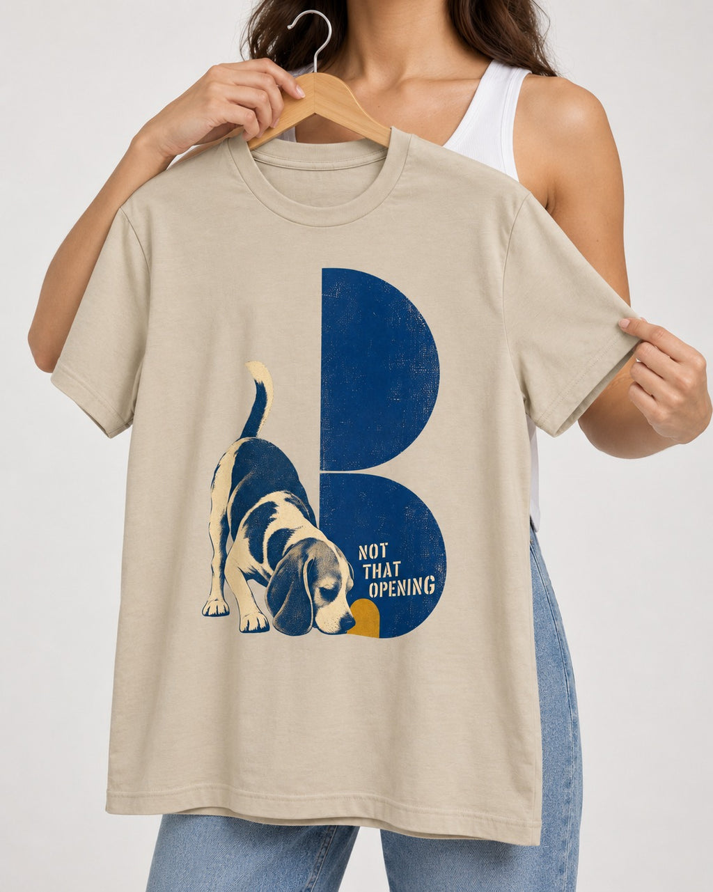 Not That Opening Beagle T-Shirt in Sand, held up on a hanger