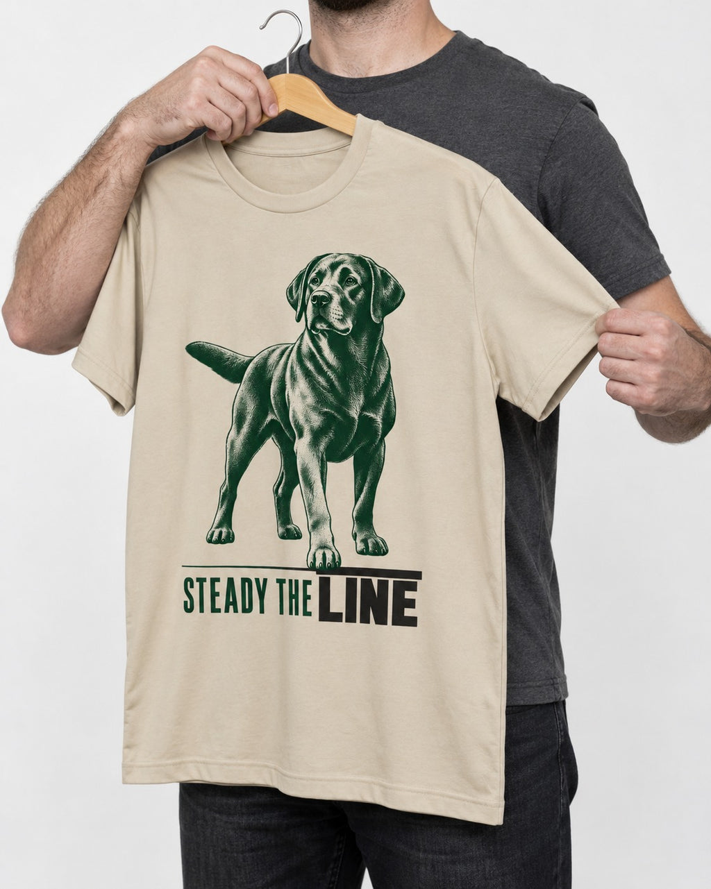 Steady the Line Labrador Retriever T-Shirt in Sand, held up on a hanger