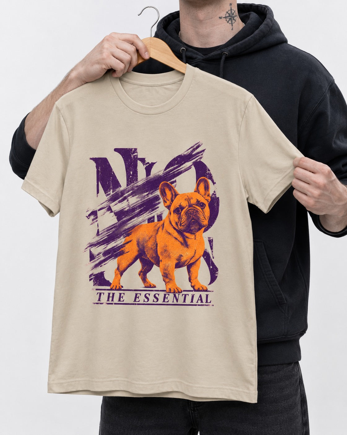 The Essential Frenchie T-Shirt in Sand, held up on a hanger