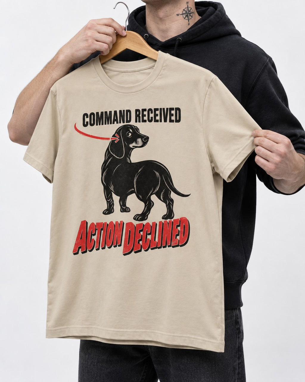 Dachshund Action Declined T-Shirt in Sand, held up on a hanger