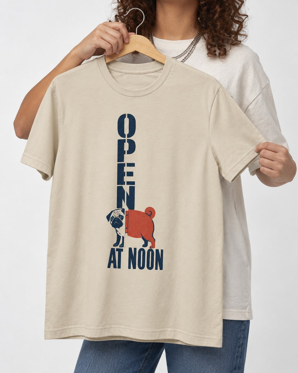 Pug Open at Noon T-Shirt in Sand, held up on a hanger