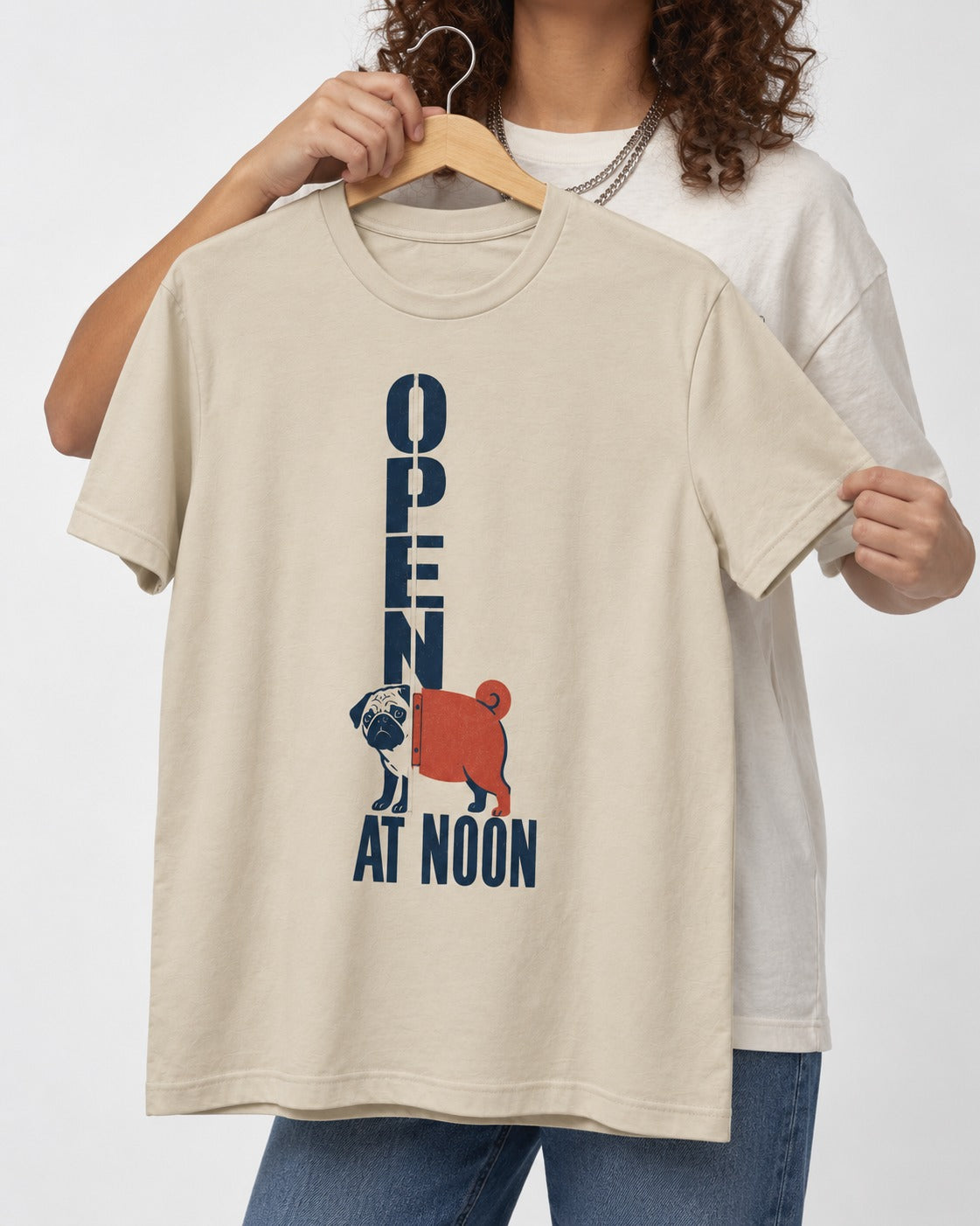 Pug Open at Noon T-Shirt in Sand, held up on a hanger